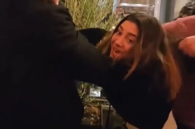 The intoxicated woman physically engages with restaurant staff, adding intensity to the conflict.