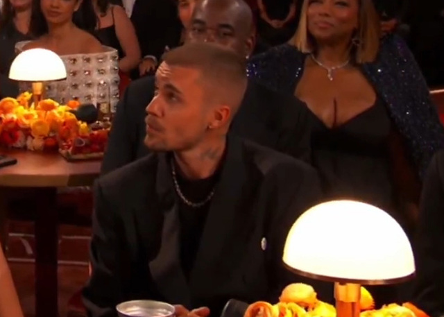 Justin Bieber’s stoic gaze and 'clamped' facial cues, which body language experts interpreted as a sign of setting firm personal boundaries.