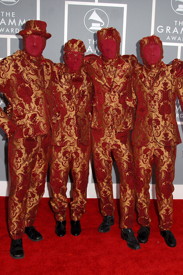 OK Go (2007) obscured their faces with red stockings while wearing impeccably tailored patterned suits.